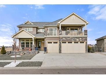 Charming two-story home with a stone facade, front porch, upper balcony, and a spacious three-car garage at 20503 E 50Th Pl, Denver, CO 80249