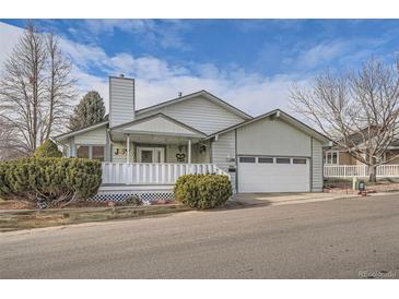 Ranch-style home with white porch and attached garage at 19 Carla Way, Broomfield, CO 80020