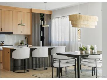 Modern kitchen with breakfast bar, sleek cabinets, and unique lighting fixtures. Perfect for entertaining and daily living at 2206 Alpine Dr, Boulder, CO 80304