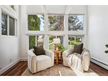 Bright sunroom with two comfy armchairs and plenty of natural light at 8387 S Reed St # B3, Littleton, CO 80128