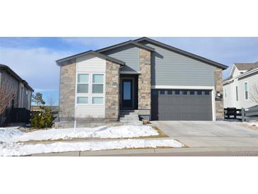 Charming two-story home featuring a stone facade and a two-car garage at 6759 Canyonpoint Rd, Castle Pines, CO 80108