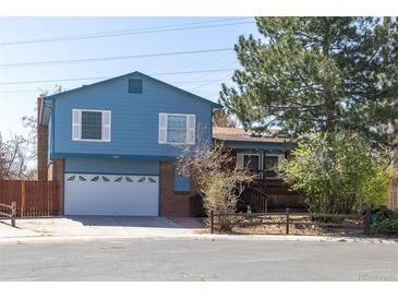 Charming two-story home featuring a brick facade and a well-manicured front yard on a sunny day at 6720 W 112Th Pl, Westminster, CO 80020