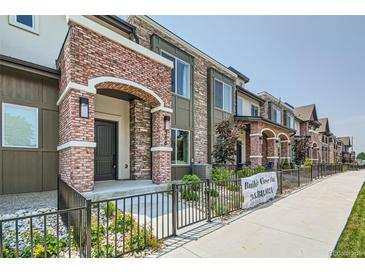 Brick townhouses with welcoming front porches and well-manicured landscaping at 388 E Orchard Rd, Centennial, CO 80121