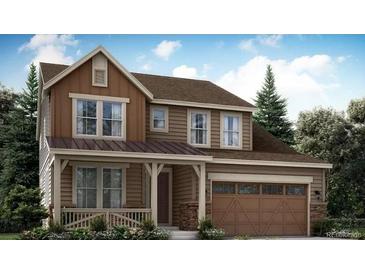 Charming two-story home with a covered porch, attached garage, and professionally landscaped yard at 14513 Hudson Way, Thornton, CO 80602