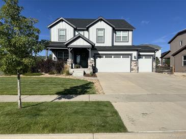 Charming two-story home with a three-car garage and beautifully landscaped front yard at 8739 Culebra St, Arvada, CO 80007