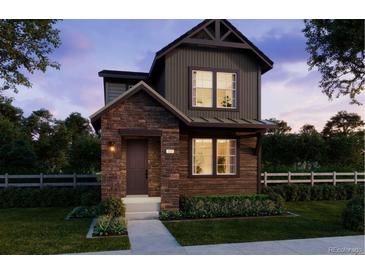 Charming two-story home featuring a combination of wood and stone accents, complemented by well-maintained landscaping at 7245 Goldbloom Ln, Littleton, CO 80125