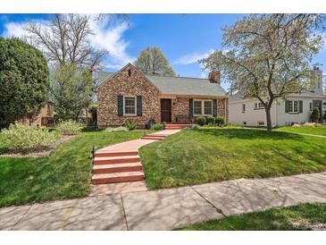 Charming brick home featuring a well-manicured lawn and a inviting pathway at 1572 Leyden St, Denver, CO 80220