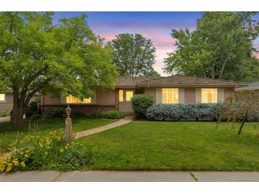 Charming single-story home with a well-manicured lawn and inviting walkway at 2309 E Floyd Pl, Englewood, CO 80113