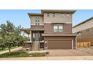 Two-story home featuring a covered front porch, garage and professionally landscaped front yard at 2592 Sweet Wind Ave, Castle Rock, CO 80109