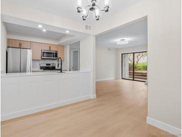 A modern kitchen with stainless steel appliances and updated cabinetry at 3141 S Tamarac Dr # 111G, Denver, CO 80231