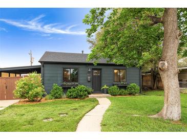 Charming home featuring a well-maintained lawn, lovely landscaping, and a welcoming walkway at 1411 S Beach Ct, Denver, CO 80219