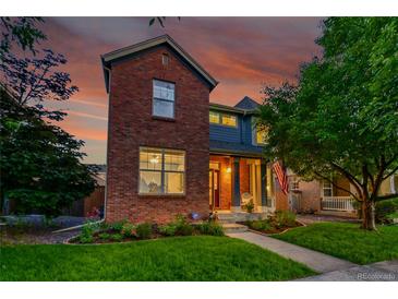 Charming brick home with landscaped front yard, and an inviting covered porch, perfect for enjoying the sunset at 7064 E 2Nd Ave, Denver, CO 80220