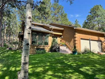 Charming home with a well-maintained lawn and inviting curb appeal at 85 S Sherwood Gln, Monument, CO 80132