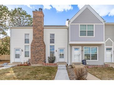 Charming townhomes with light exteriors and landscaped front yards offer comfortable and stylish living at 3281 S Estes St, Lakewood, CO 80227