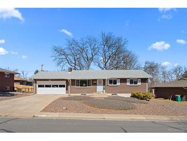 Charming brick ranch-style home with a well-maintained front yard and attached two-car garage at 12087 W New Mexico Ave, Lakewood, CO 80228