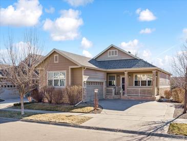 Charming single-story home featuring a covered front porch, attached garage and manicured landscaping at 7964 S Rome Ct, Aurora, CO 80016