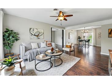 Inviting living room featuring modern decor, stylish furniture, and hardwood flooring throughout at 1047 Scranton St, Aurora, CO 80011