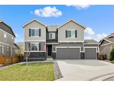 Charming two-story home with a three-car garage and well-maintained lawn at 6827 Leilani Ln, Castle Rock, CO 80108
