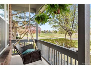 Inviting front porch with a swing and hanging plants, perfect for relaxing outdoors at 3422 W 125Th Dr, Broomfield, CO 80020
