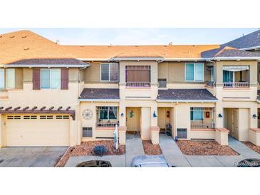 Charming townhome featuring a front yard and attached garage in a well-kept neighborhood at 833 E 98 Ave # 204, Thornton, CO 80229
