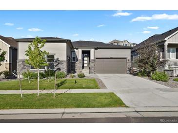 Charming single-Gathering home with a two-car garage, stone accents, and well-maintained landscaping at 12938 Bridge View Ln, Parker, CO 80134