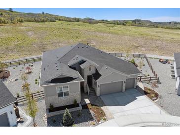 Stunning single Gathering home with three-car garage, beautiful landscaping, and mountain views at 547 Scrubjay Cir, Castle Rock, CO 80104