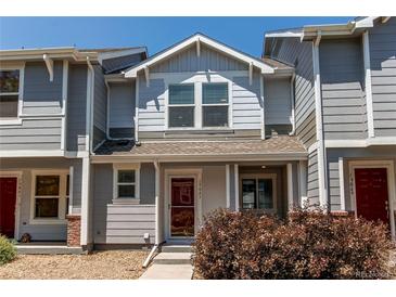 Charming two-story home with gray siding and a cozy front porch at 19043 E 58Th Ave, Denver, CO 80249