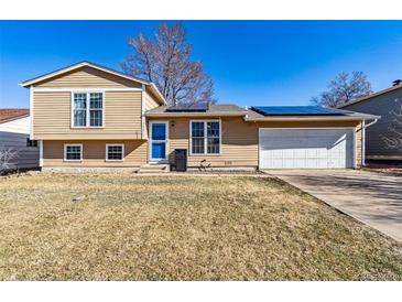 Charming two-story home featuring solar panels, a well-maintained lawn, and a attached two-car garage at 16277 E Arkansas Dr, Aurora, CO 80017