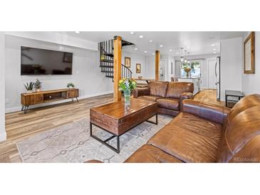 Inviting living room with wood floors, leather furniture and a modern staircase at 112 Illinois Gulch Rd # 6, Breckenridge, CO 80424