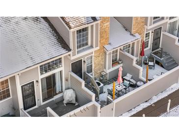 Aerial view of townhome showcasing deck, patio, and well-maintained facade with snow-dusted roof at 5155 W 68Th Ave # 5, Westminster, CO 80030