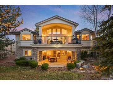 Expansive backyard featuring a stone patio and balcony perfect for outdoor entertaining at 1 Canon Pl, Greenwood Village, CO 80111
