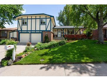 Charming two-story home with well-maintained lawn, lush landscaping, and a two-car garage at 10520 W 101St Pl, Westminster, CO 80021