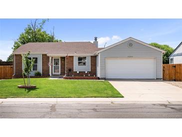 Charming single-Gathering home with a well-manicured lawn and attached two-car garage at 11323 Albion St, Thornton, CO 80233