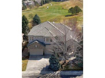 An aerial view of a beautiful property backing onto a golf course with mature trees at 10260 Longview Dr, Lone Tree, CO 80124