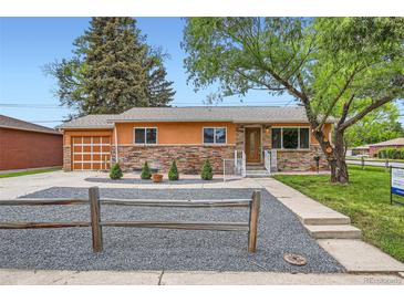 Charming single-story home showcasing a stone facade, orange trim, and well-maintained landscaping at 3107 S Wolff St, Denver, CO 80236