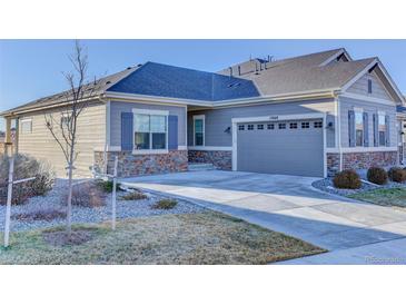Charming single-story home featuring stone accents and a spacious driveway leading to the attached garage at 12668 Ulster St, Thornton, CO 80602