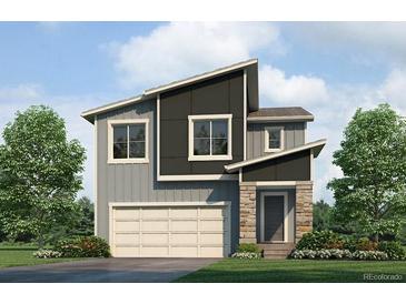 Modern two-story home showcases mixed siding, a two-car garage, and landscaped lawn at 18009 Dandy Brush Ln, Parker, CO 80134