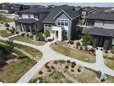 Beautifully landscaped home featuring modern architecture, walkways, and neutral gray tones in a desirable neighborhood at 1732 Stable View Dr, Castle Pines, CO 80108