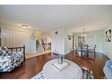 Inviting living room with hardwood floors and staircase to the upper level at 8364 Allison Ct, Arvada, CO 80005