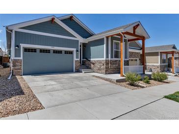 Charming home with a well-manicured lawn, attached garage, and beautiful stone accents at 11494 Colony Loop, Parker, CO 80138