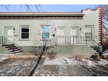 Charming duplex exterior with a classic brick design and inviting front entrances at 3059 Curtis St, Denver, CO 80205