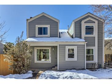 Gray two-story house with snow-covered roof and yard at 11612 E Cornell Cir, Aurora, CO 80014