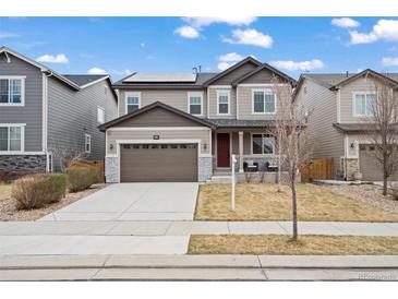 Charming two-story home featuring a neutral color scheme and a well-manicured front yard at 6220 Waterman Way, Frederick, CO 80516