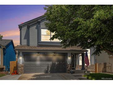 Charming two-story home with gray siding, stone accents, and a well-maintained front yard at 2782 S Ceylon St, Aurora, CO 80013