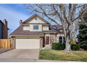 Charming two-story home featuring a well-manicured lawn, brick accents, and an attached two-car garage at 5733 S Killarney Way, Centennial, CO 80015