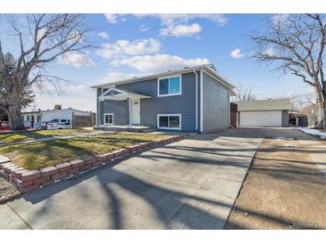 Gray exterior house with a landscaped yard and a two-car garage at 9525 Damon Dr, Northglenn, CO 80260