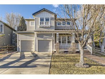 Two-story home with a two-car garage, covered porch, and neutral-colored siding at 16364 Flintlock Ct, Parker, CO 80134