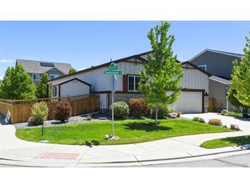 Charming home with well-maintained lawn and landscaped garden at 6049 Sandstone Cir, Erie, CO 80516