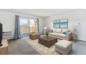 Bright living room with a sliding glass door to the balcony and comfortable seating arrangement at 635 S Alton Way # 12C, Denver, CO 80247