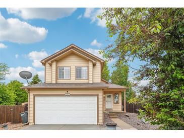Charming two-story home with a well-maintained lawn, attached garage and beautiful front entrance at 5262 E Sandpiper Ave, Castle Rock, CO 80104